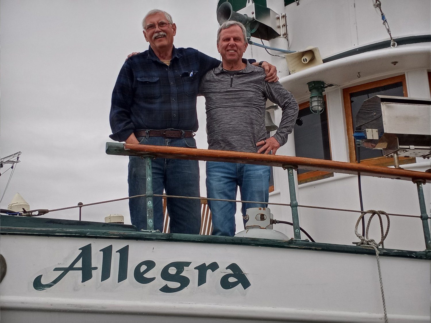 Kevin and an older friend on the deck of the boat Allegra