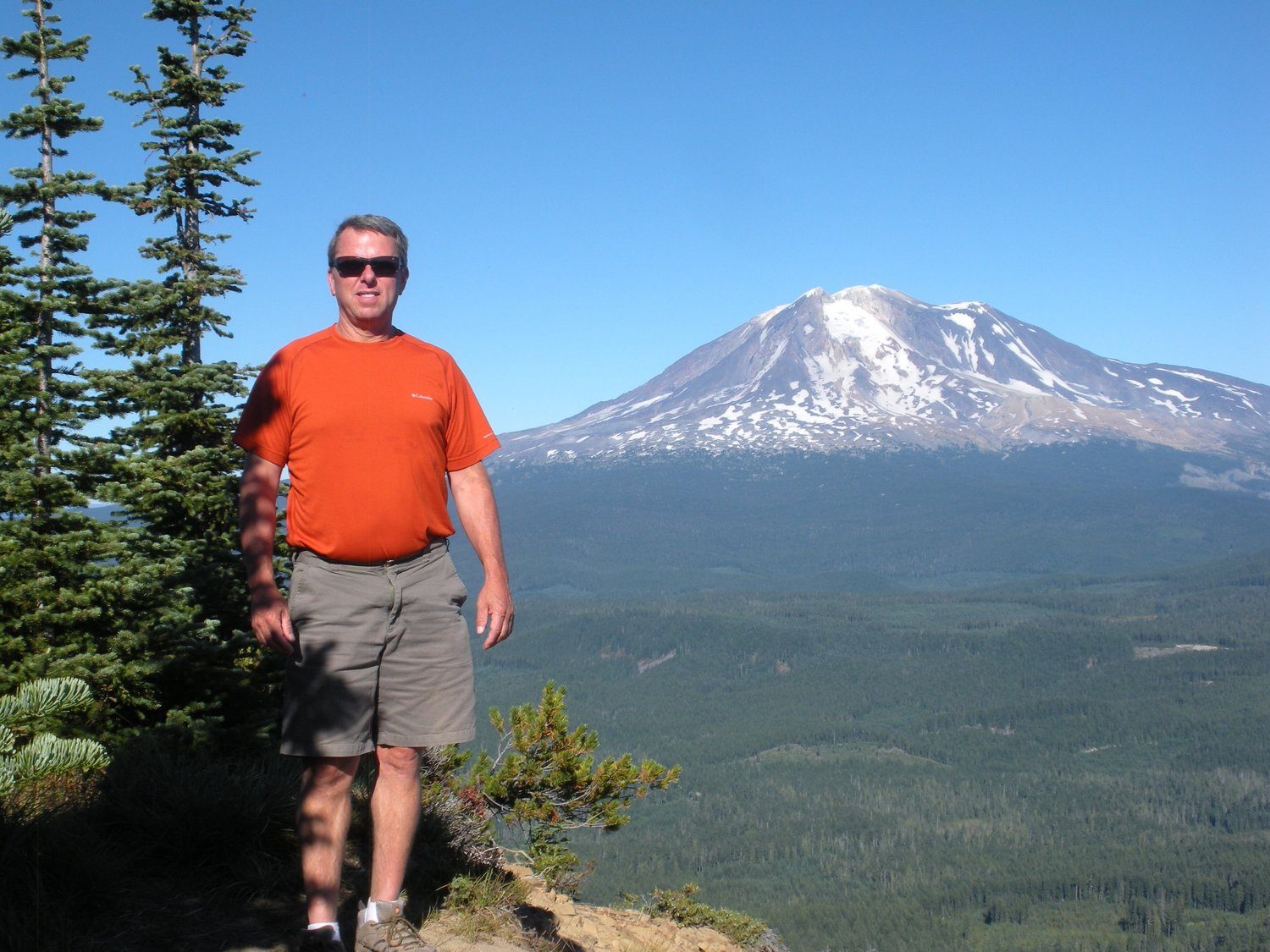 Standing on a ridge with a snowy volcano in the distance