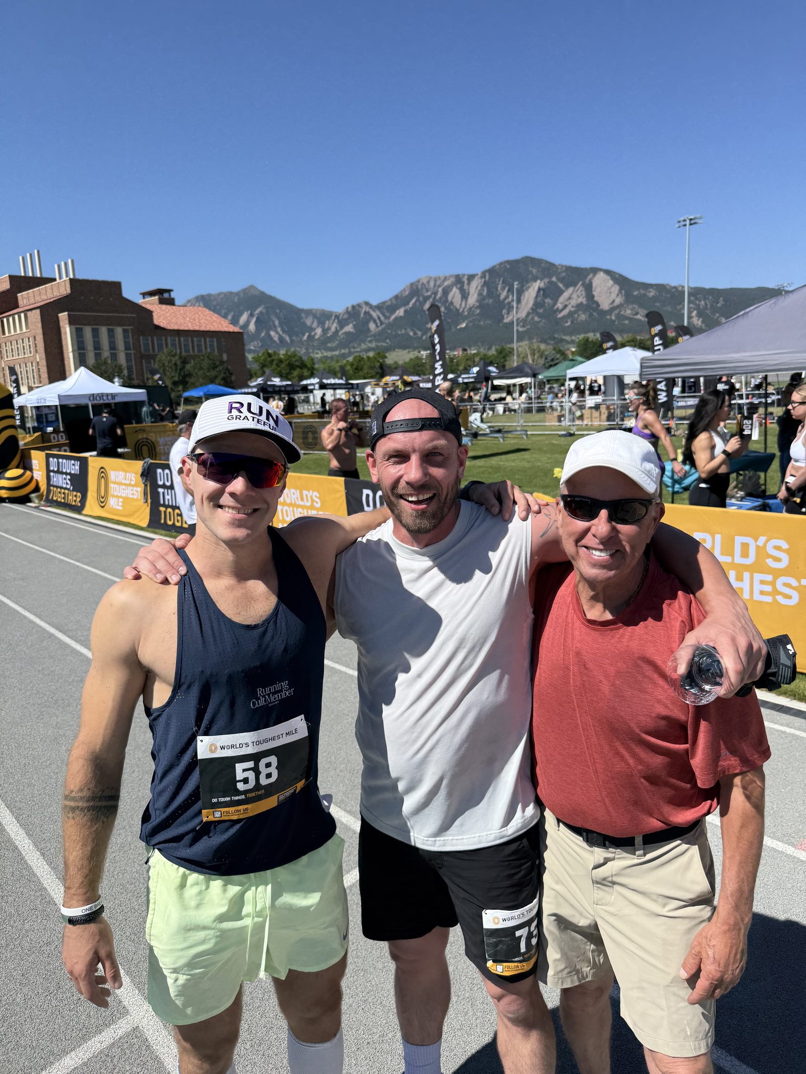 Collin, a friend, and Kevin at the starting event in Boulder with the Flatirons behind them